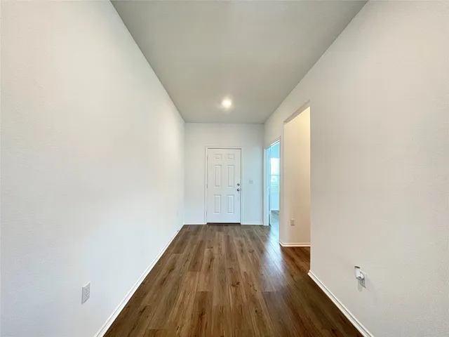 a view of hallway with wooden floor
