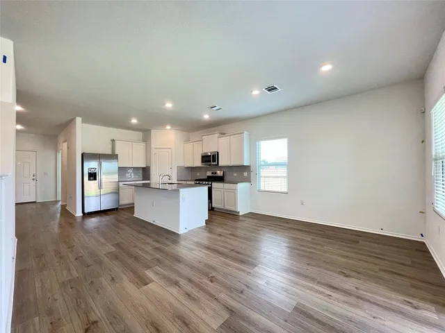 a view of kitchen with wooden floor and windows