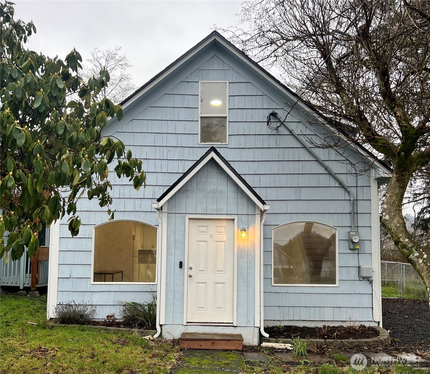 a view of house with backyard