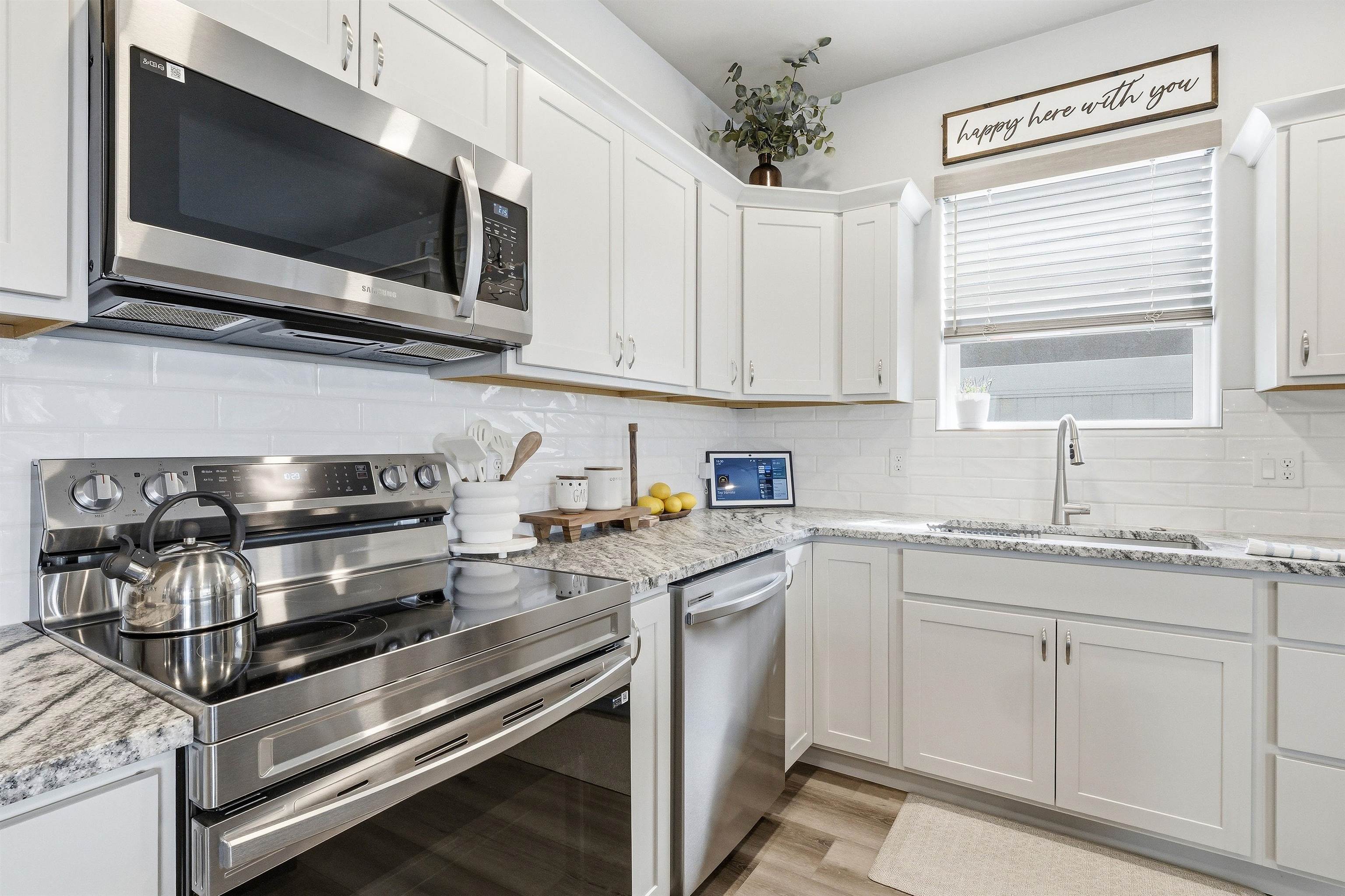 2459 Hamilton Road, Unit A Grand Junction, CO 81505 - Photo 8 of 27 a kitchen with stainless steel appliances a stove microwave and sink