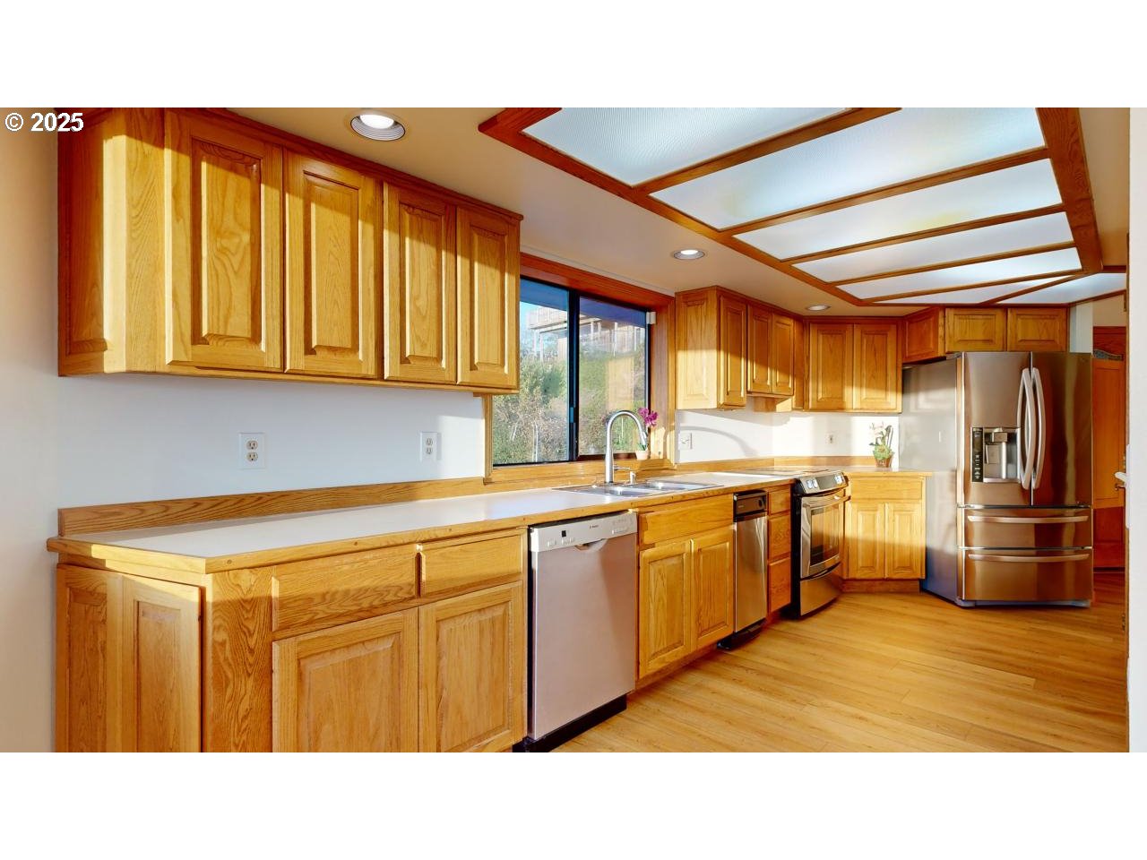 16151 Lower Harbor Road Brookings, OR 97415 - Photo 11 of 43 a kitchen with stainless steel appliances granite countertop a sink and cabinets