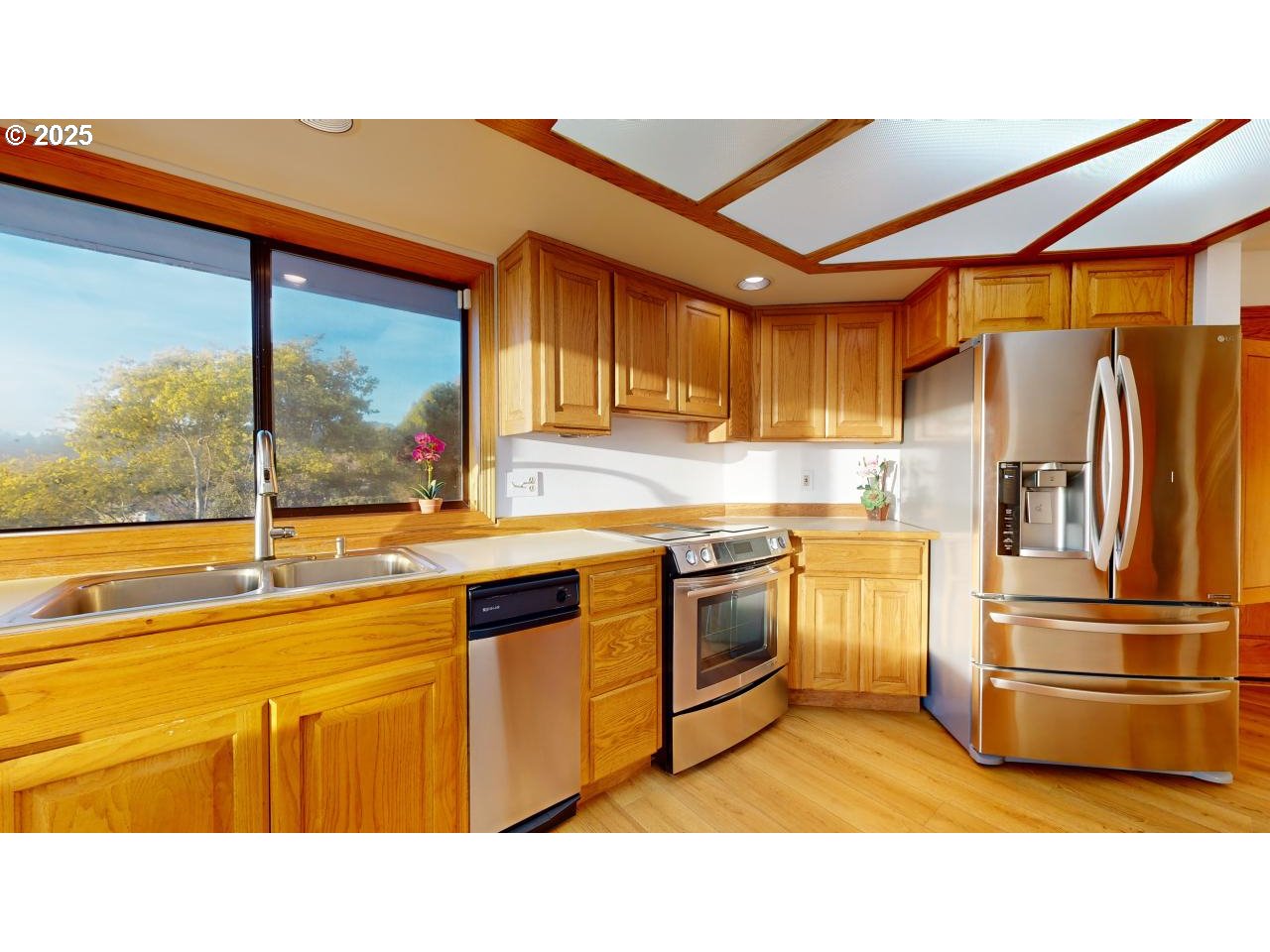 16151 Lower Harbor Road Brookings, OR 97415 - Photo 12 of 43 a kitchen with granite countertop a sink stainless steel appliances and cabinets