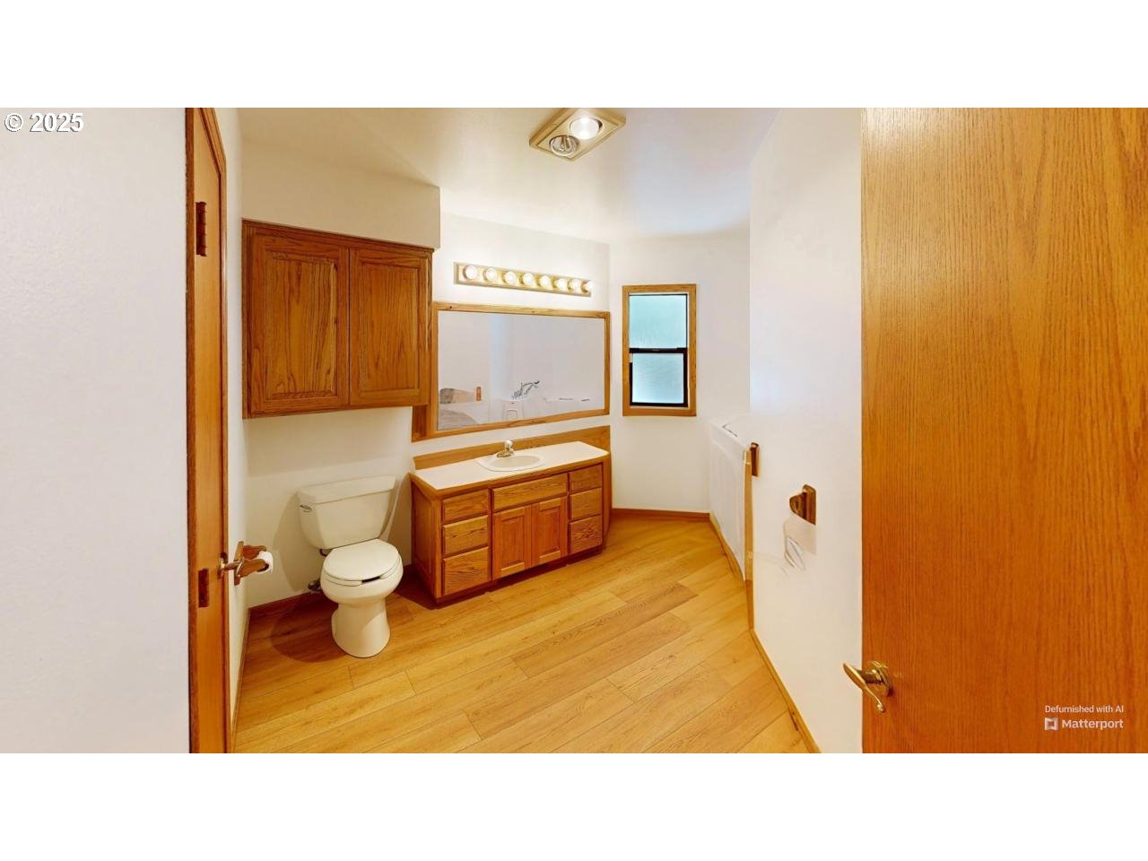 16151 Lower Harbor Road Brookings, OR 97415 - Photo 29 of 43 a bathroom with a sink mirror vanity and toilet