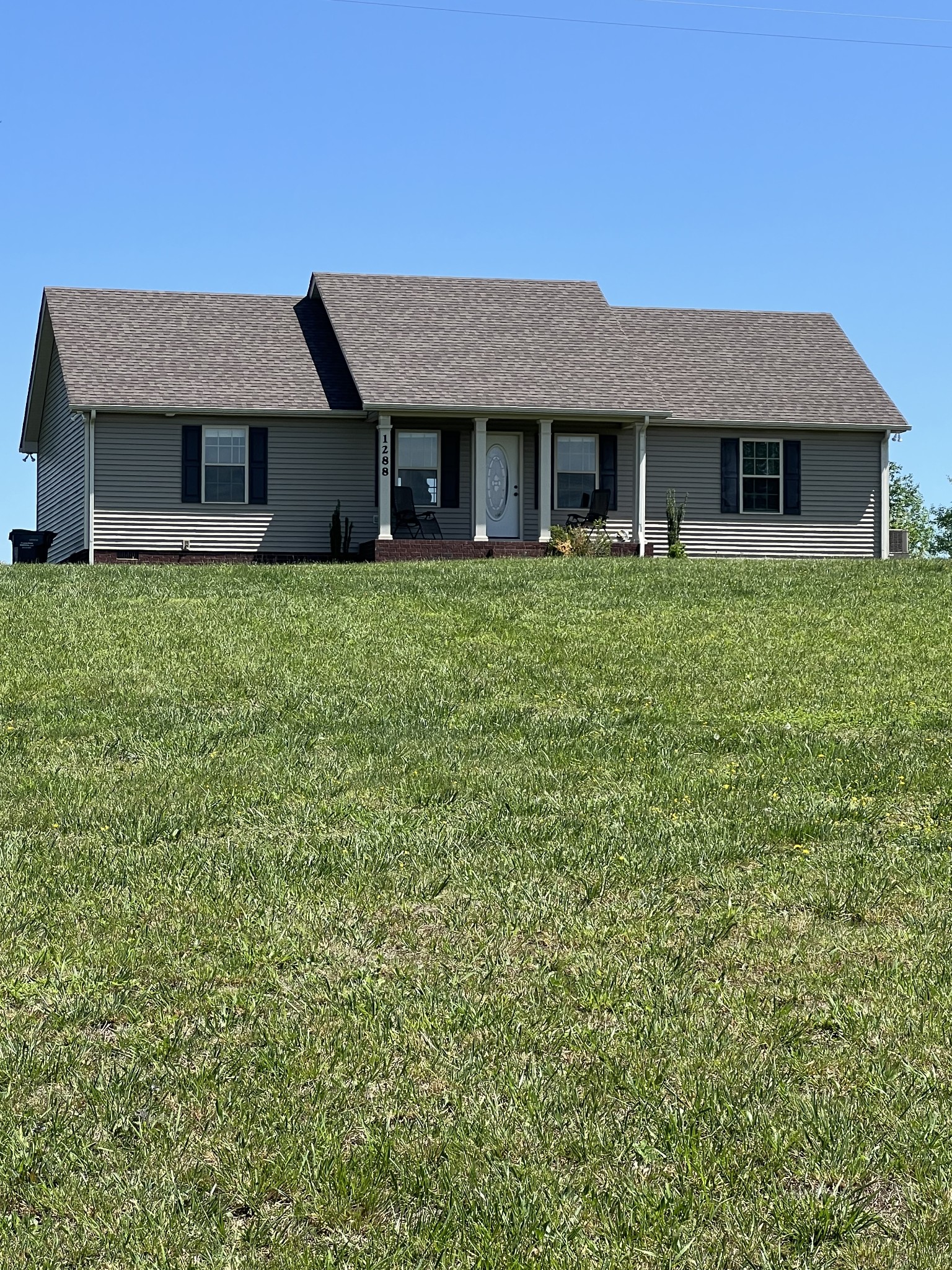 a front view of a house with a garden