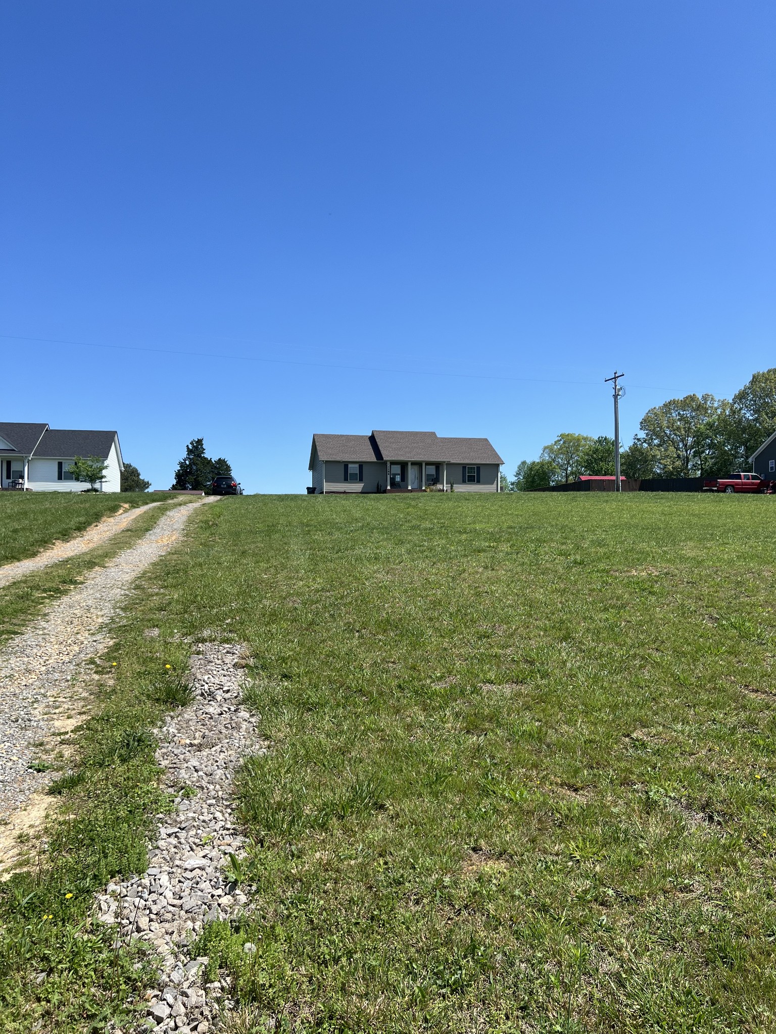 1288 Mt Olive Road Westmoreland, TN 37186 - Photo 16 of 16 a view of a big yard with a house in the background