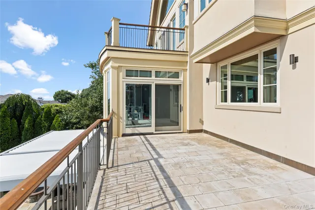 a view of a house with many windows and a park