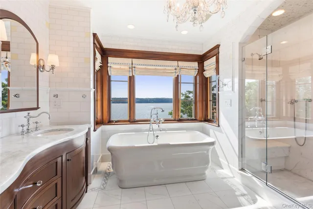 a large spacious bathroom with a large tub sink and mirror