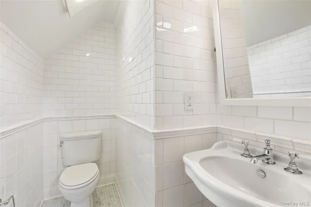 a bedroom with a bed couch and a large window with outer view