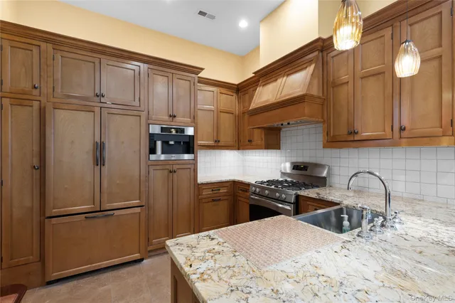 a kitchen with stainless steel appliances granite countertop a stove and a refrigerator
