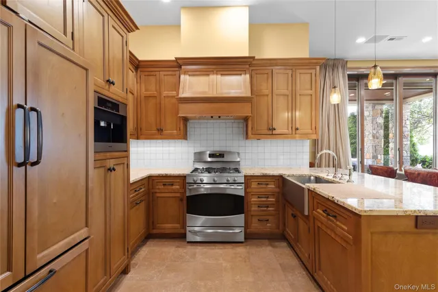 a kitchen with stainless steel appliances granite countertop a stove and a sink