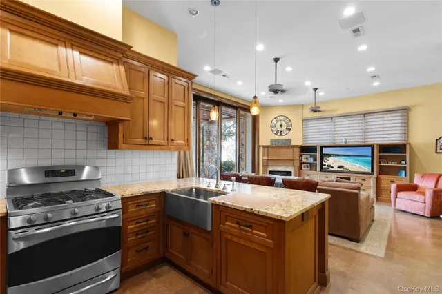 a living room with fireplace furniture and a flat screen tv