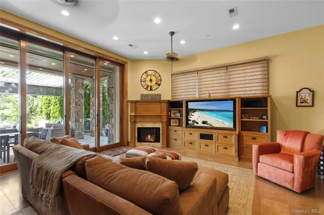 a living room with fireplace furniture and a flat screen tv