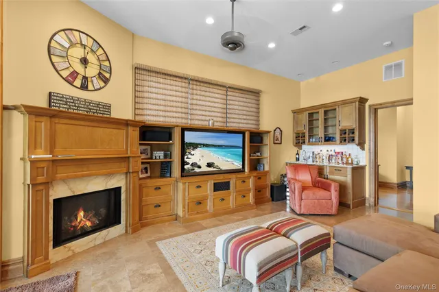 a living room with furniture kitchen area and a large window