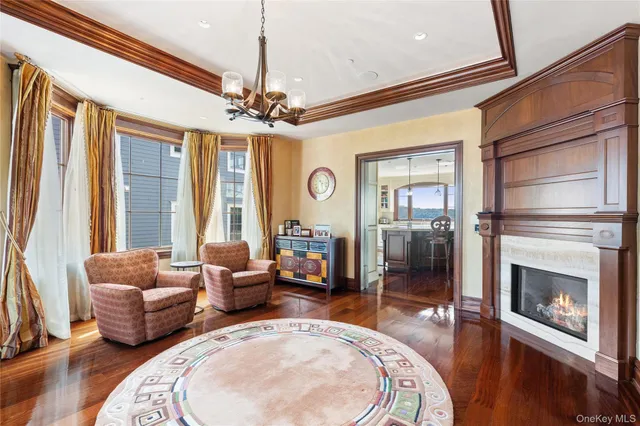 a living room with furniture a chandelier and a fireplace