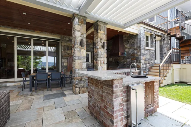 a view of an outdoor dining space with a porch