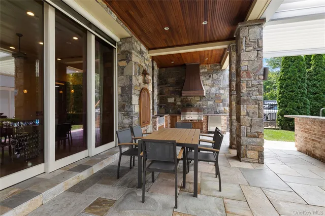 a backyard of a house with fountain and outdoor seating