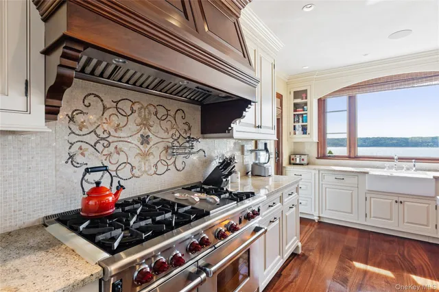 a kitchen with stainless steel appliances granite countertop a stove and a sink