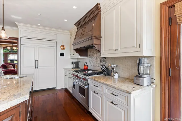a kitchen with stainless steel appliances granite countertop a stove and a refrigerator