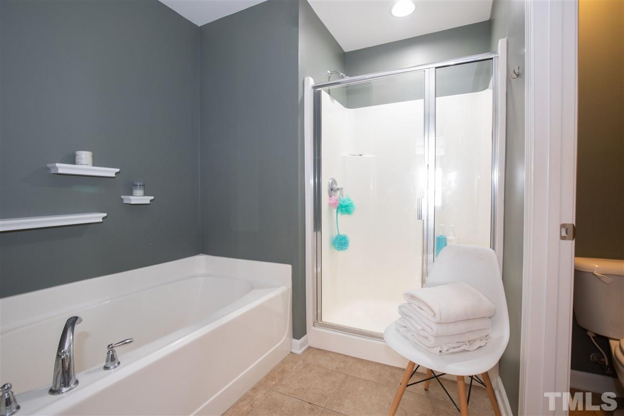 2441 Memory Ridge Drive Raleigh, NC 27606 - Photo 11 of 21 a bathroom with a tub and shower