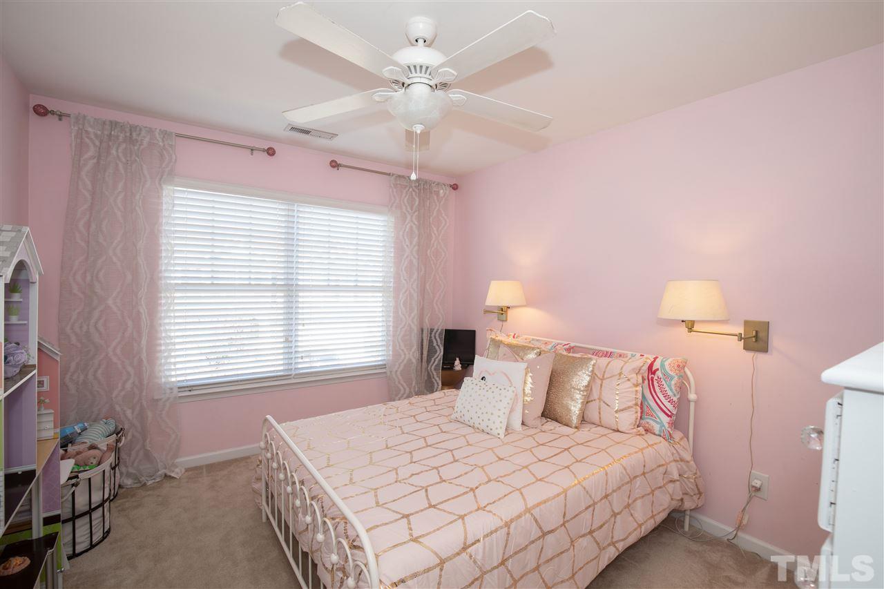 2441 Memory Ridge Drive Raleigh, NC 27606 - Photo 13 of 21 a bedroom with a bed and a chandelier