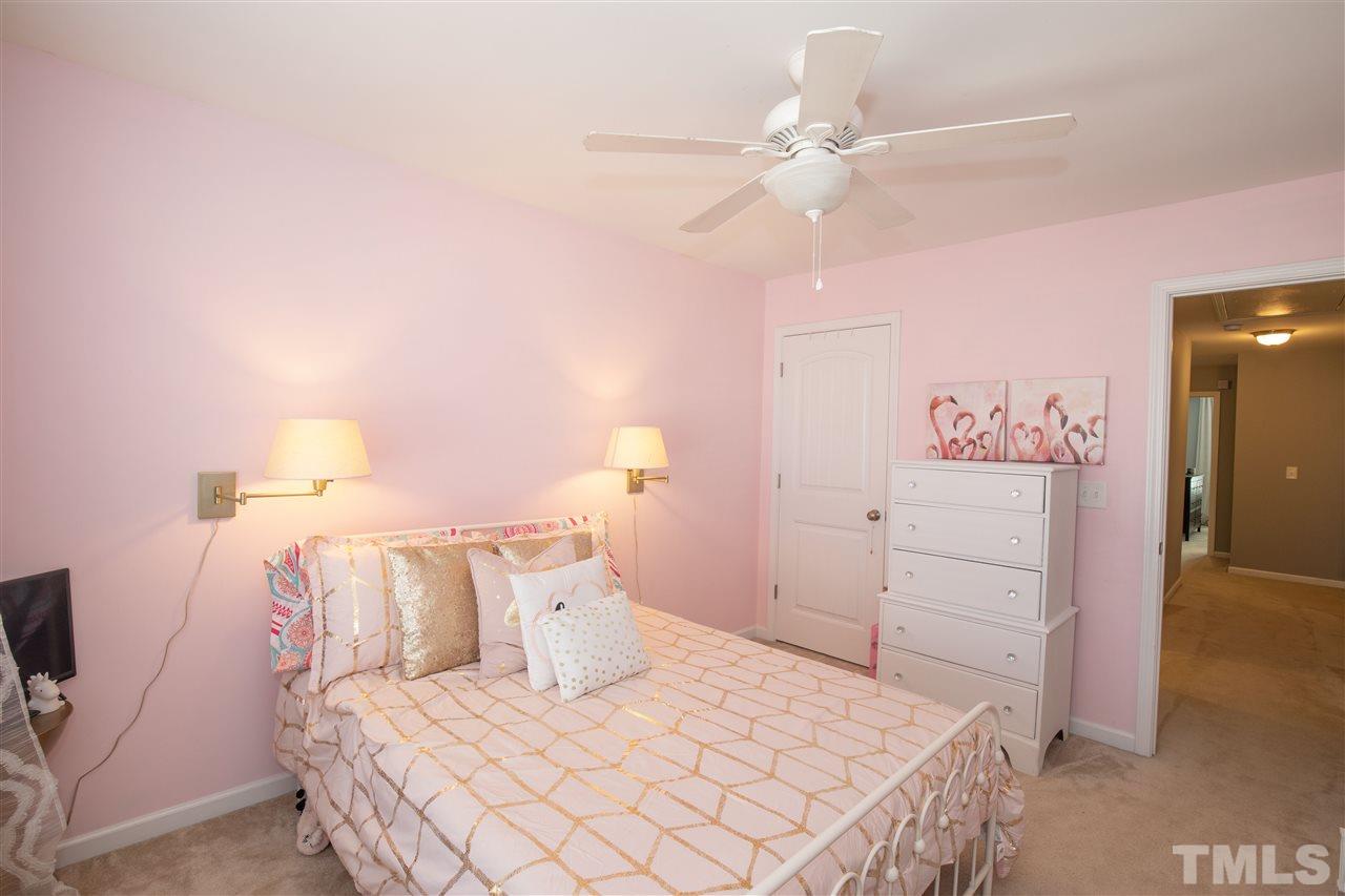2441 Memory Ridge Drive Raleigh, NC 27606 - Photo 14 of 21 a bedroom with a bed and a chandelier