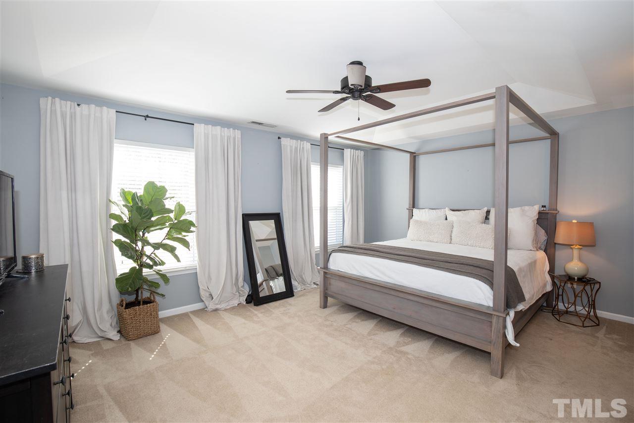 2441 Memory Ridge Drive Raleigh, NC 27606 - Photo 8 of 21 a spacious bedroom with a bed and a window