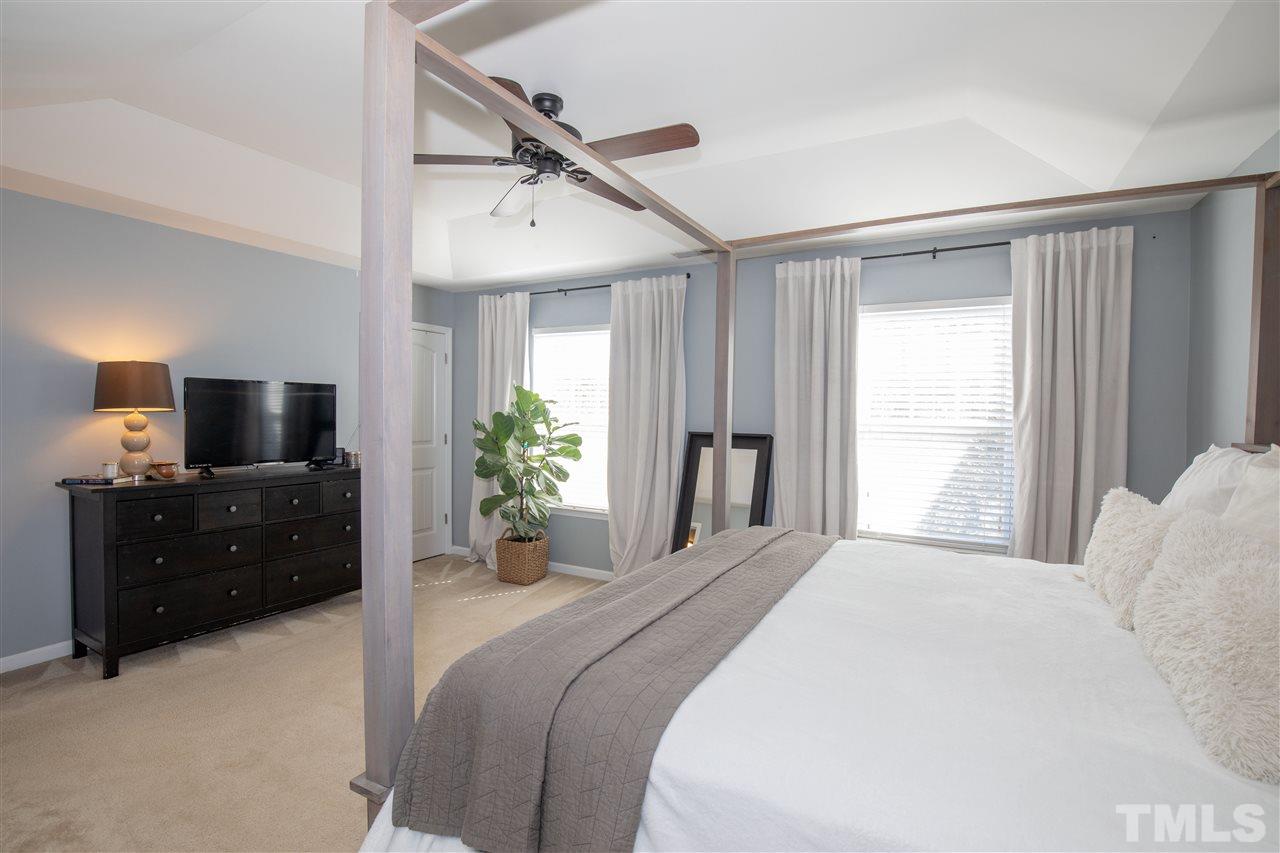 2441 Memory Ridge Drive Raleigh, NC 27606 - Photo 9 of 21 a bedroom with a bed a flat screen tv and a window