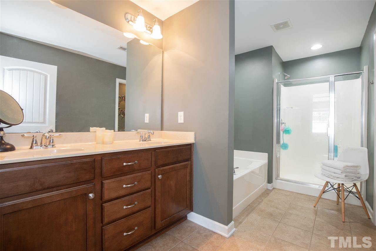 2441 Memory Ridge Drive Raleigh, NC 27606 - Photo 10 of 21 a bathroom with a double vanity sink and a mirror