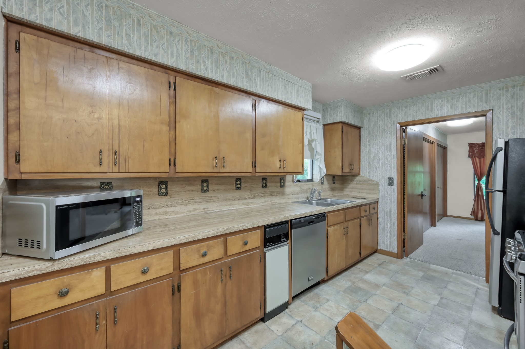 254 Sharp Lane Trinity, TX 75862 - Photo 14 of 36 a large kitchen with stainless steel appliances granite countertop a sink and cabinets
