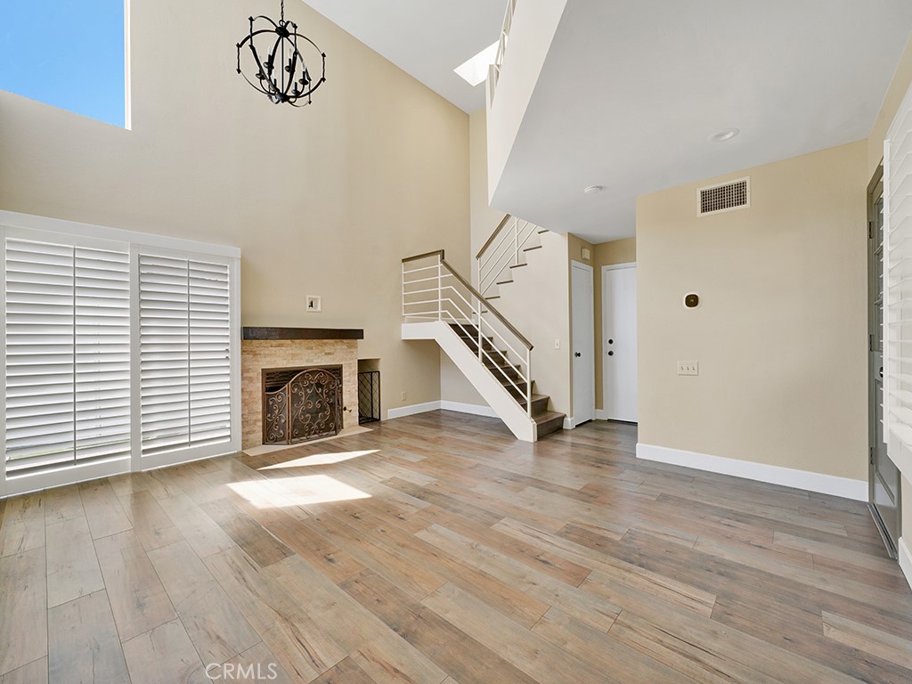 604 Via Espiritu San Clemente, CA 92672 - Photo 23 of 50 a view of a livingroom with wooden floor a fireplace and windows