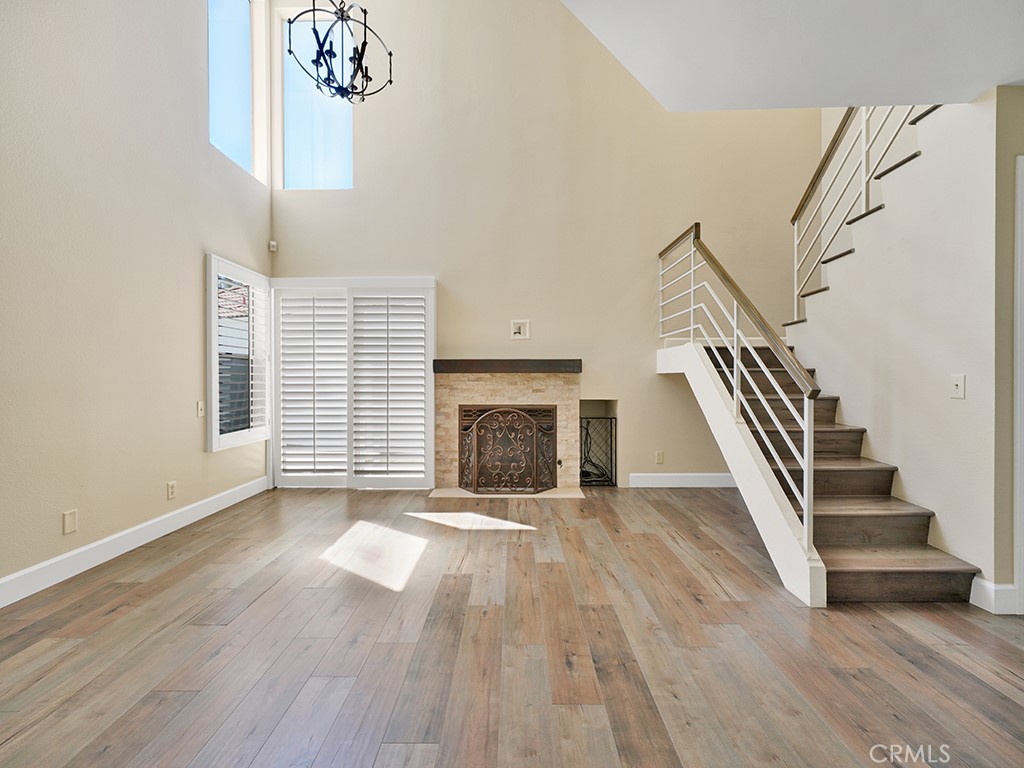 604 Via Espiritu San Clemente, CA 92672 - Photo 24 of 50 a view of a livingroom with wooden floor a fireplace and windows