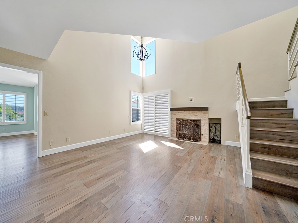 604 Via Espiritu San Clemente, CA 92672 - Photo 26 of 50 an empty room with wooden floor fireplace and windows