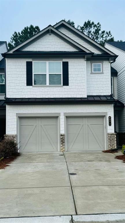 a front view of a house with a garage