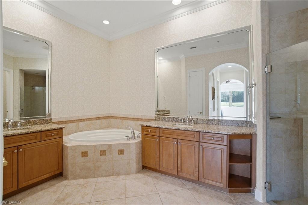 17015 Porta Vecchio Way, Unit 101 Naples, FL 34110 - Photo 14 of 39 a spacious bathroom with a granite countertop sink and a mirror