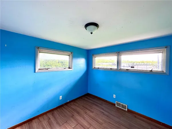 a view of an empty room with windows