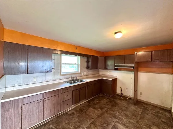 a kitchen with stainless steel appliances granite countertop a sink and cabinets