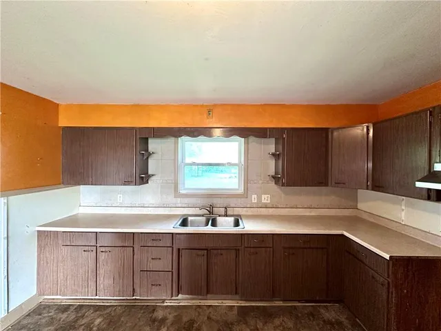 a kitchen with stainless steel appliances granite countertop a sink and cabinets