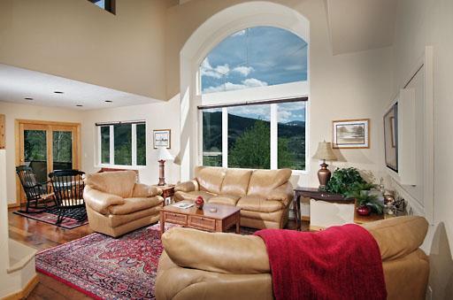 11 Hackamore Road, Unit B Edwards, CO 81632 - Photo 4 of 20 a living room with furniture fireplace and a large window