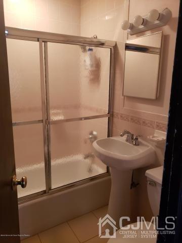 16 Rodney Road East Brunswick, NJ 08816 - Photo 5 of 12 a bathroom with a sink and mirror with bathtub