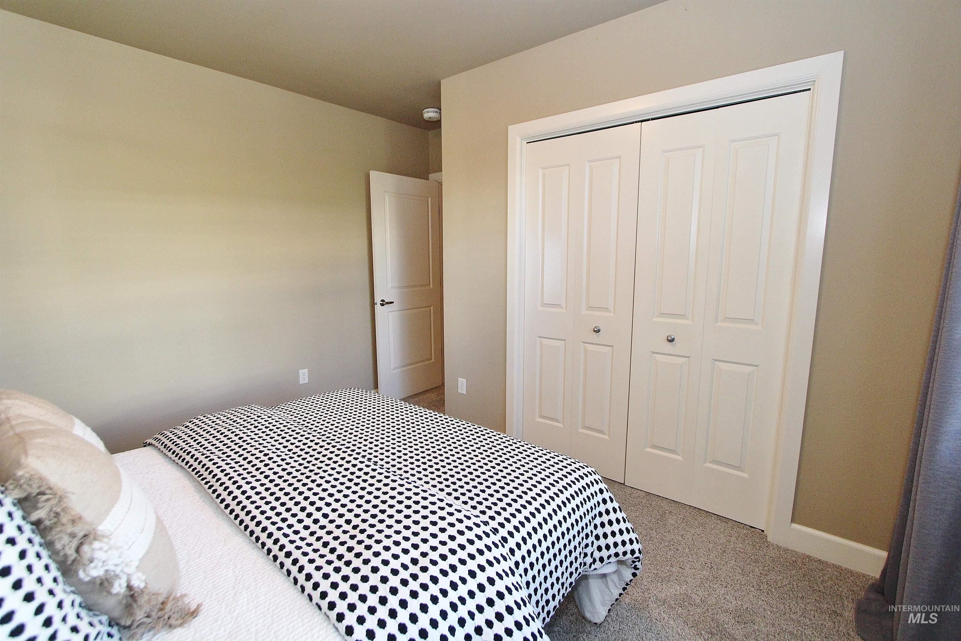 406 South 13th Street, Unit 303 Boise, ID 83702 - Photo 12 of 18 Bedroom featuring a closet and light carpet