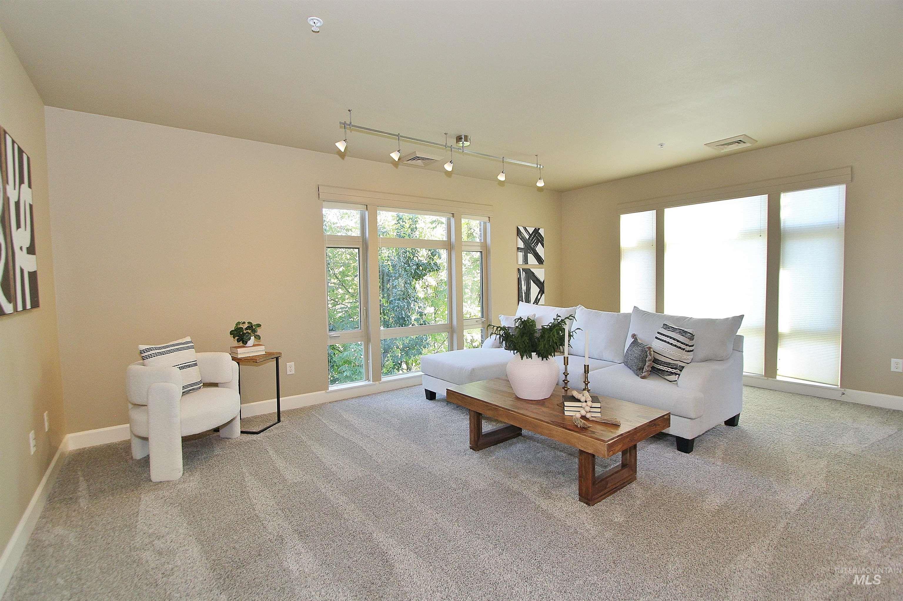 406 South 13th Street, Unit 303 Boise, ID 83702 - Photo 4 of 18 Living area featuring track lighting and light colored carpet