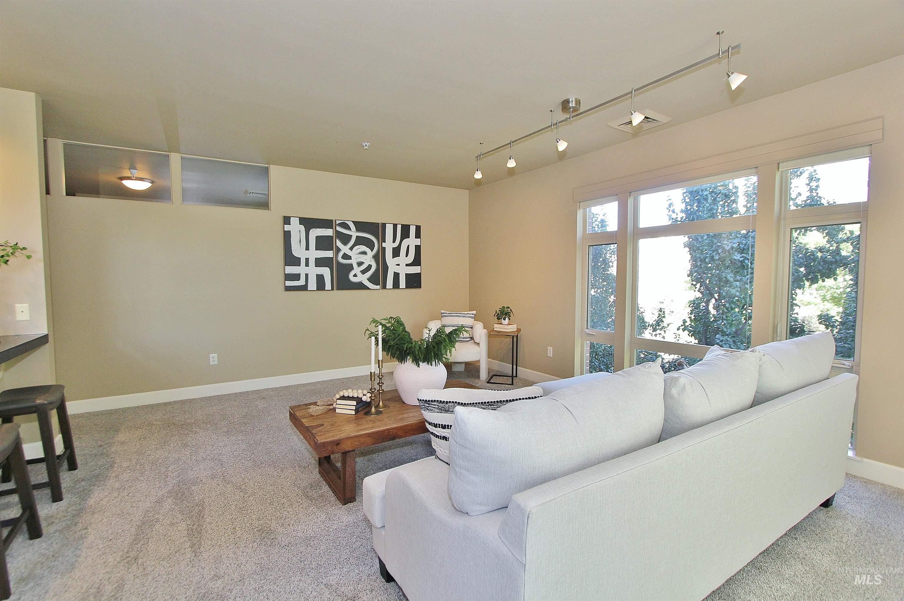 406 South 13th Street, Unit 303 Boise, ID 83702 - Photo 5 of 18 Living area with rail lighting and light carpet