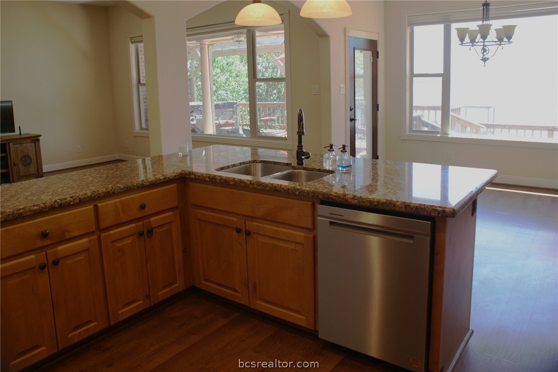 259 Memphis Bell Lane Trinity, TX 75862 - Photo 12 of 50 a kitchen with stainless steel appliances granite countertop a sink a window and wooden cabinets