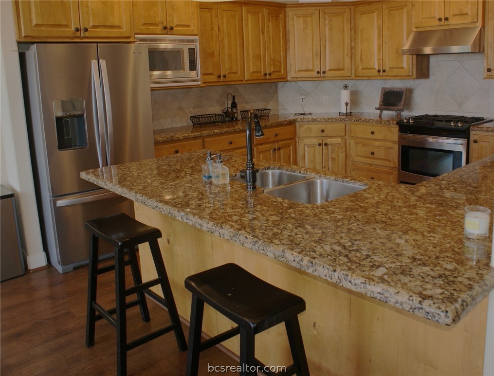 259 Memphis Bell Lane Trinity, TX 75862 - Photo 14 of 50 a kitchen with stainless steel appliances granite countertop a sink stove and refrigerator