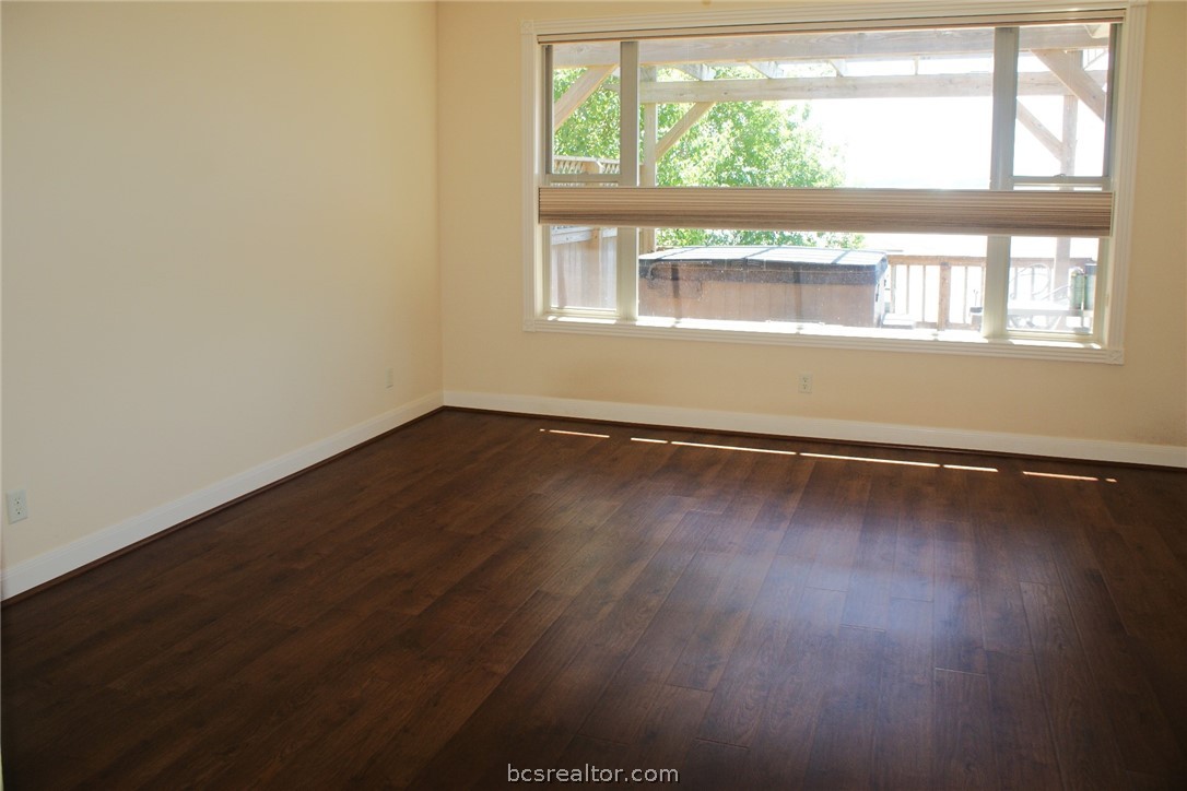 259 Memphis Bell Lane Trinity, TX 75862 - Photo 20 of 50 an empty room with wooden floor and windows