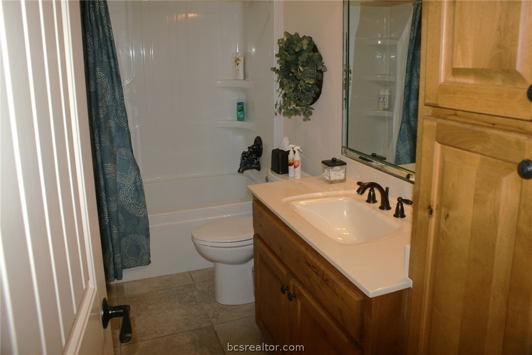 259 Memphis Bell Lane Trinity, TX 75862 - Photo 25 of 50 a bathroom with a sink a toilet and shower curtain