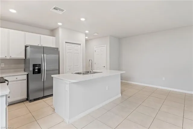 a kitchen with stainless steel appliances a refrigerator sink and stove
