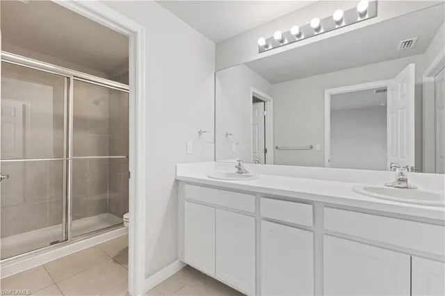 a bathroom with a double vanity sink and a mirror