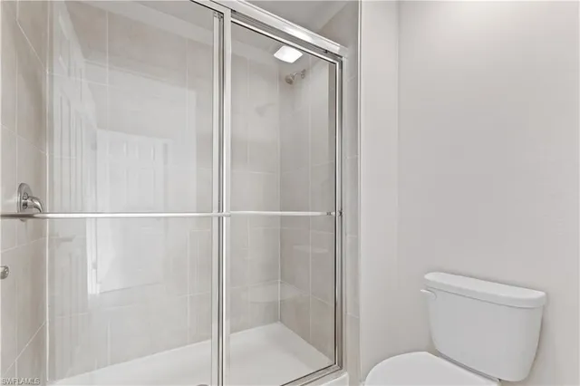 a bathroom with a shower a toilet and a sink