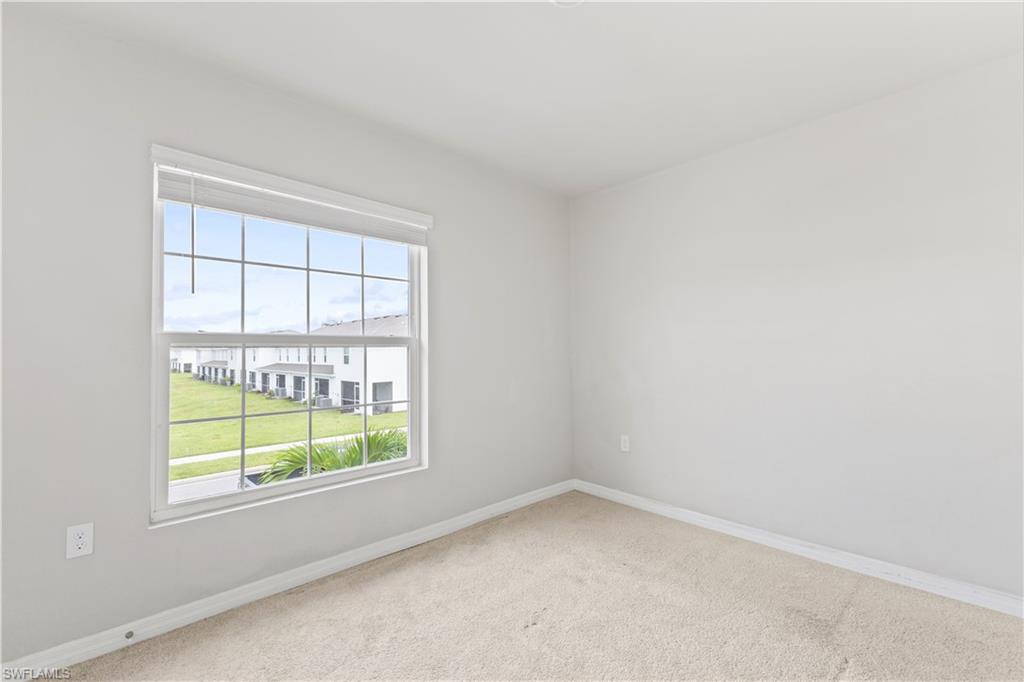 15245 Wildflower Circle Naples, FL 34119 - Photo 20 of 36 an empty room with a window